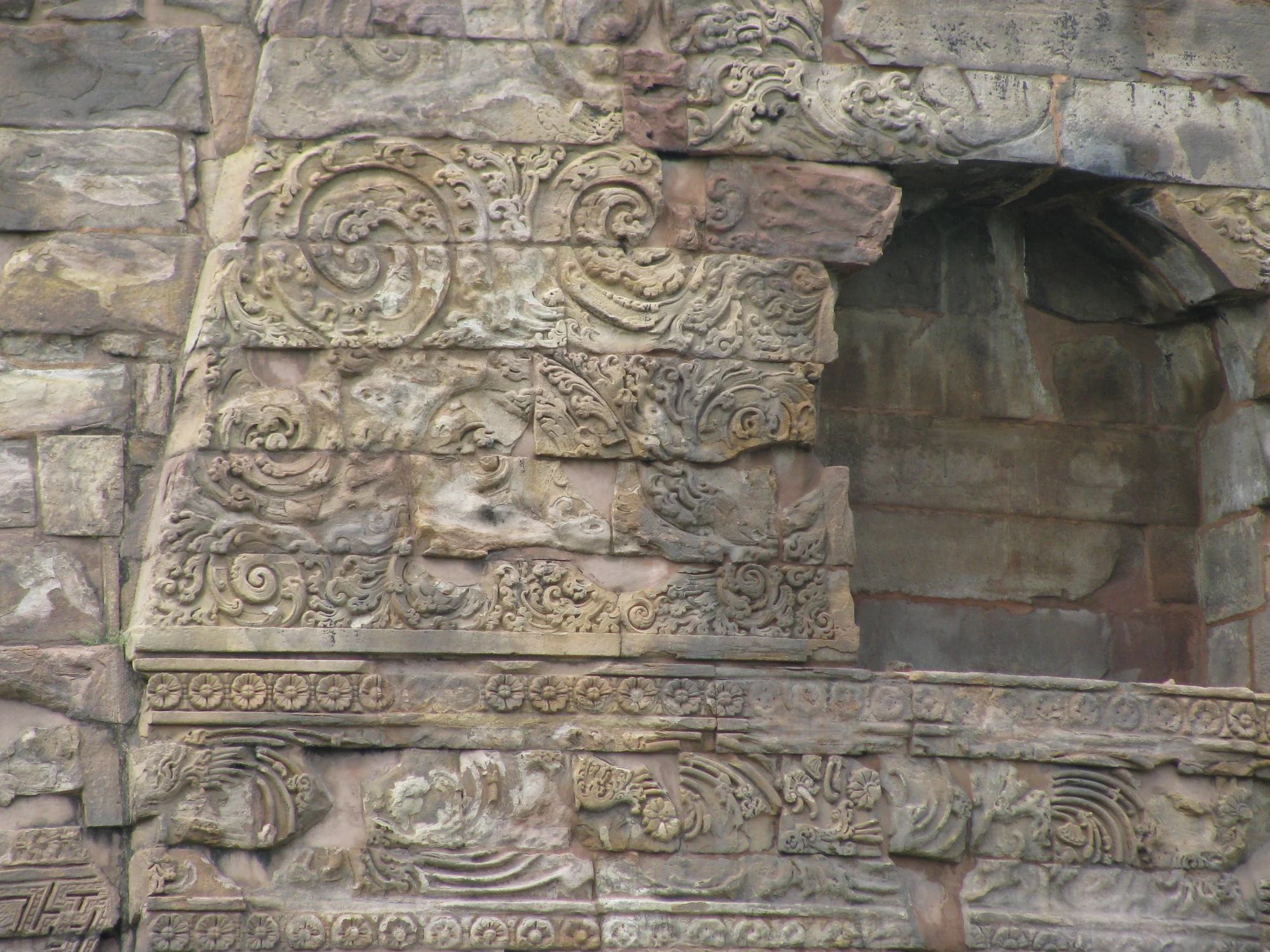 Close-up of carved geometric and floral patterns on the stupa