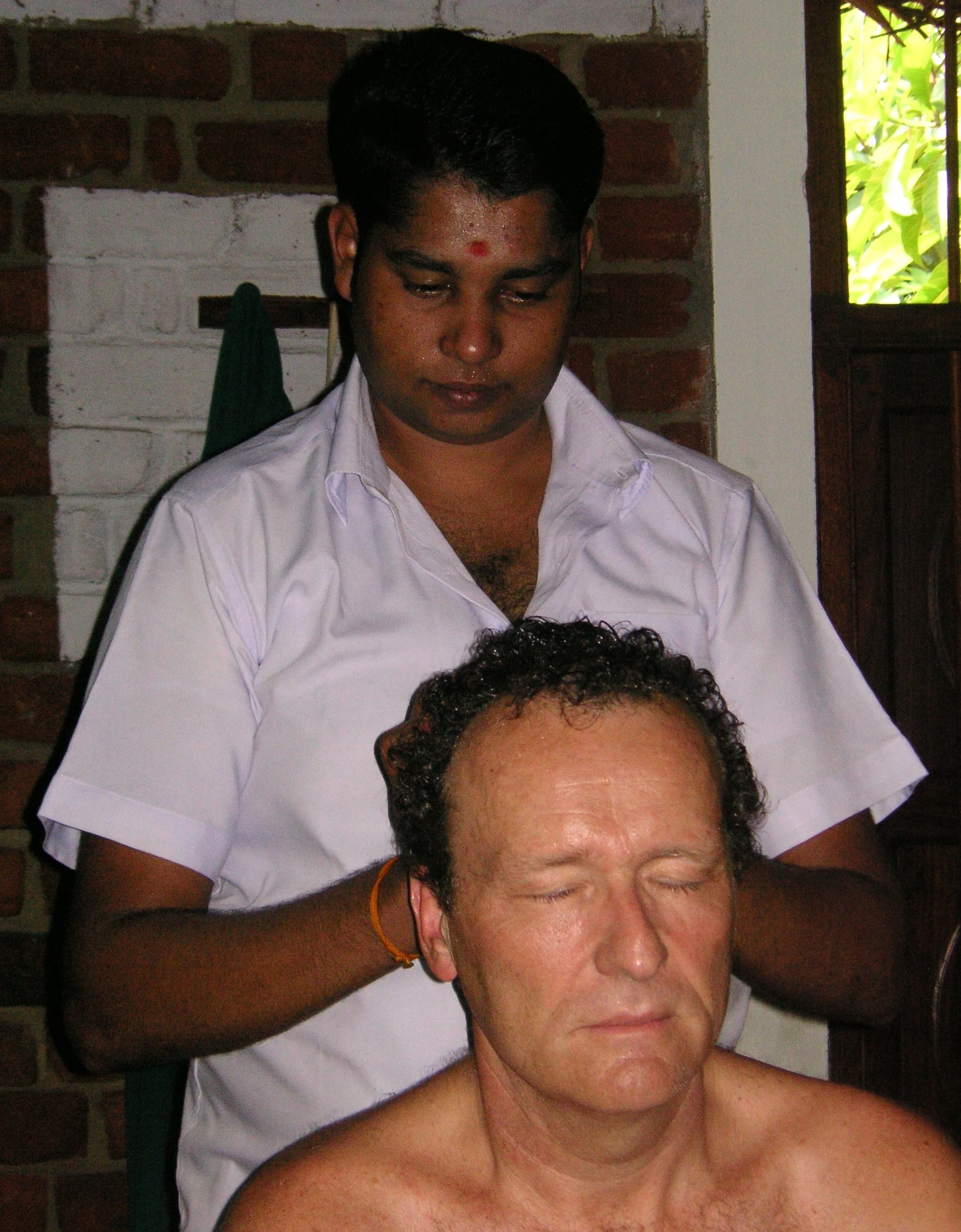 Ayurvedic head massage therapy being performed