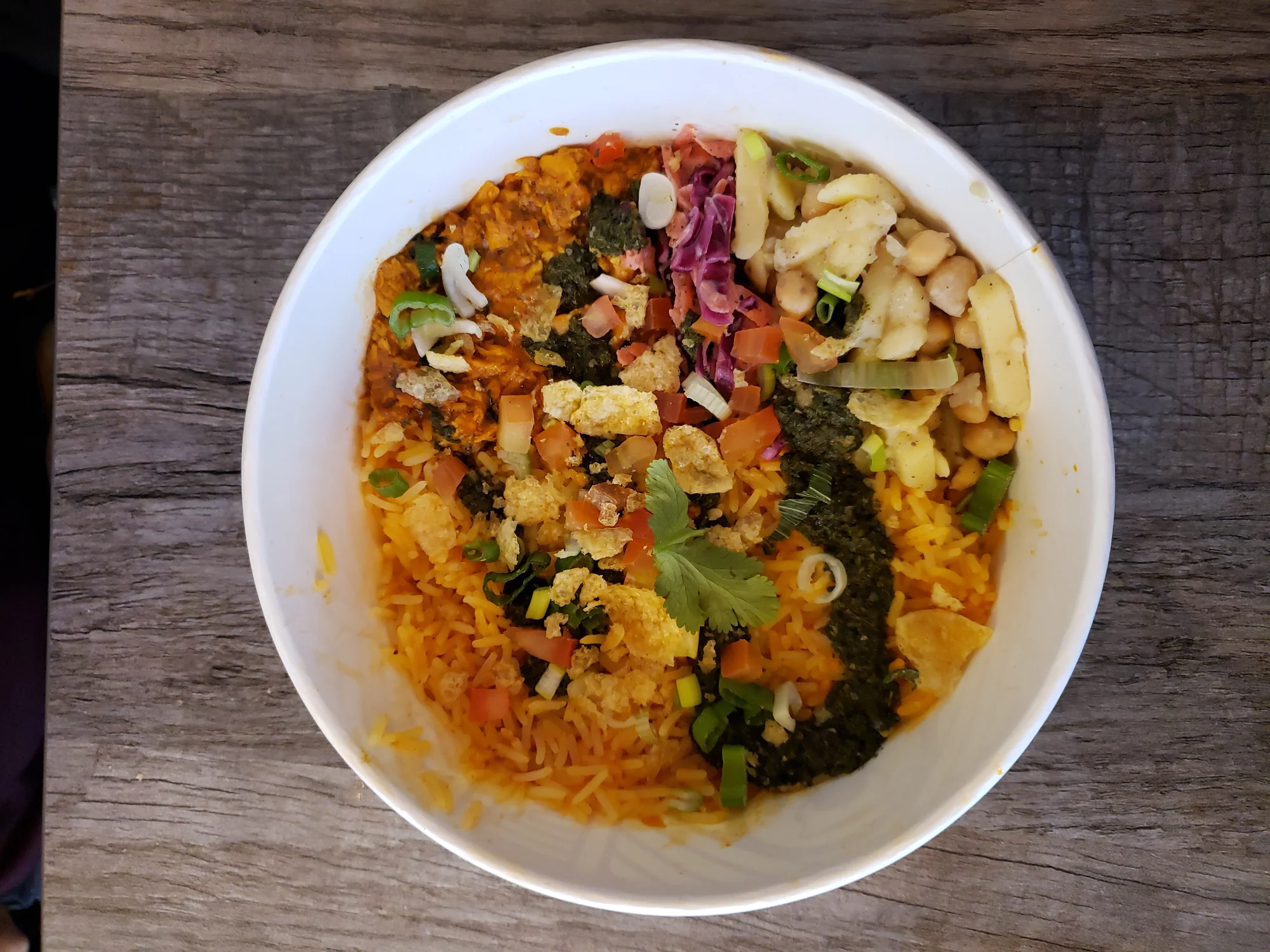 Modern presentation of butter chicken served in a bowl with rice