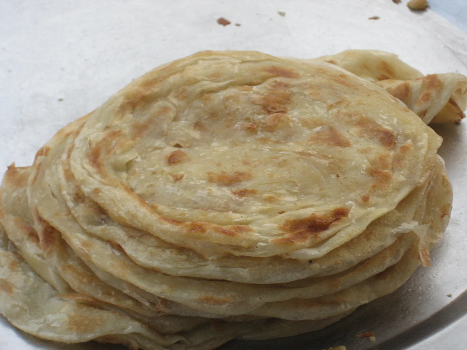 Stack of traditional parathas showing layered texture