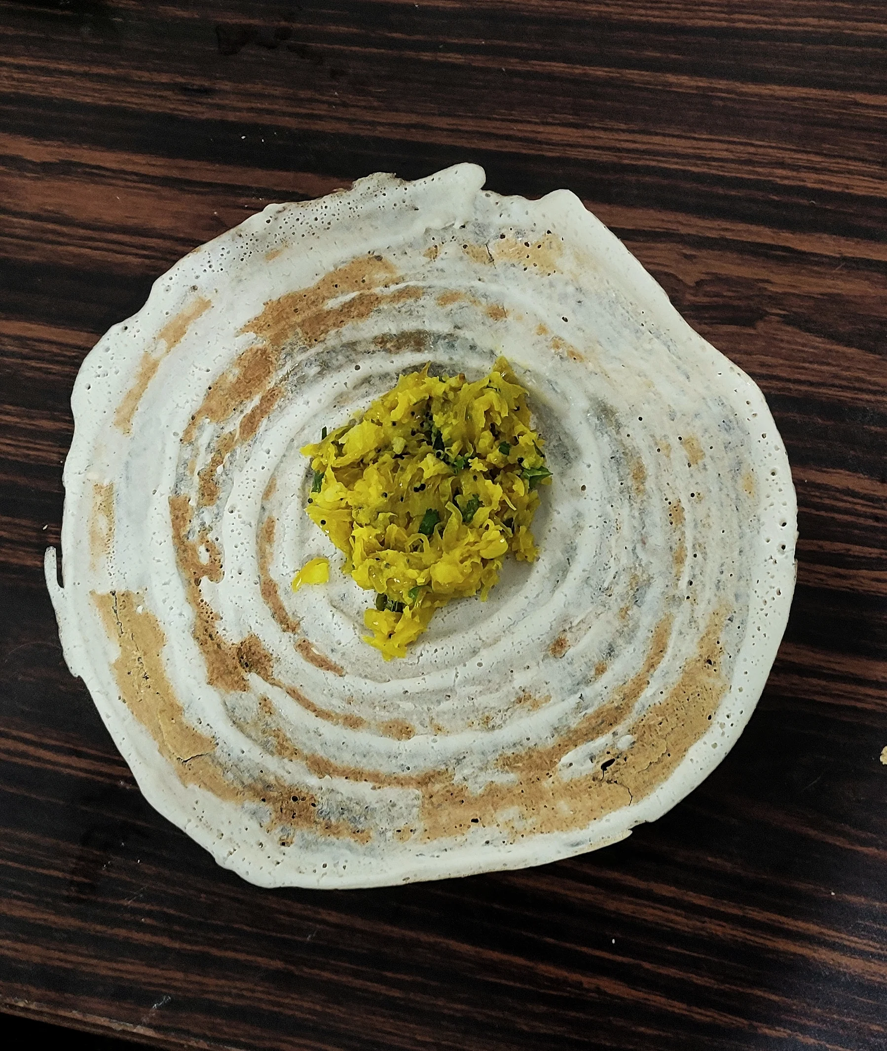 Close-up of masala dosa showing the golden crispy texture and potato filling