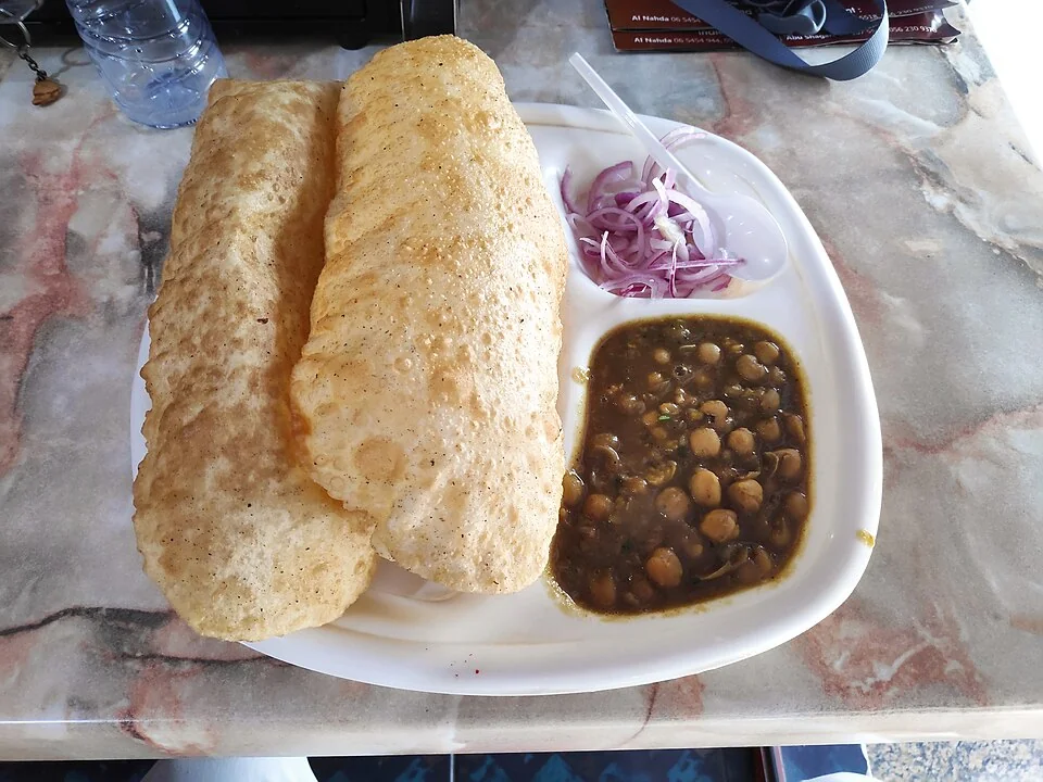 Close-up of chole bhature showing the texture of bhature and curry