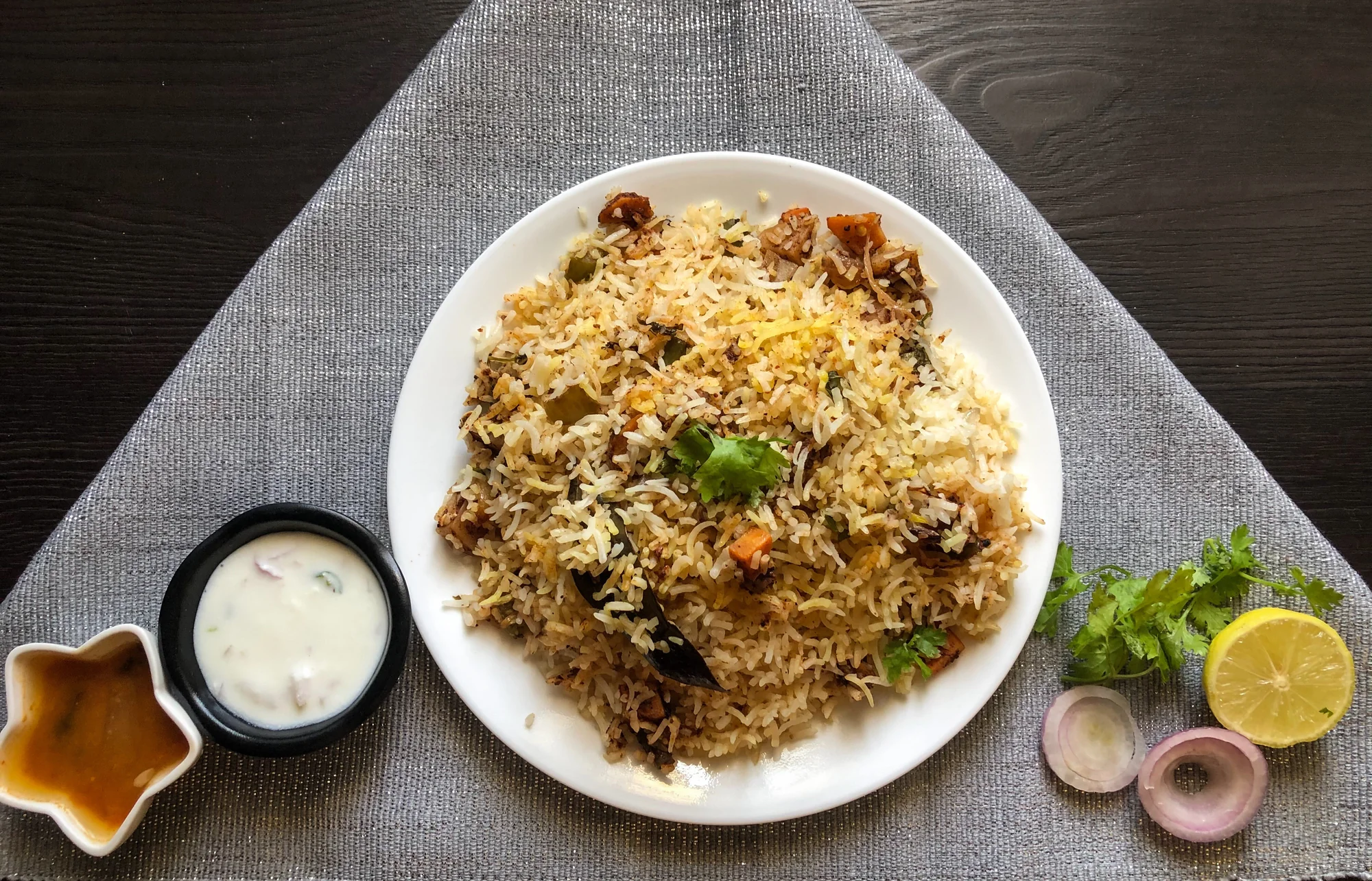 Hyderabadi dum biryani in a traditional serving vessel