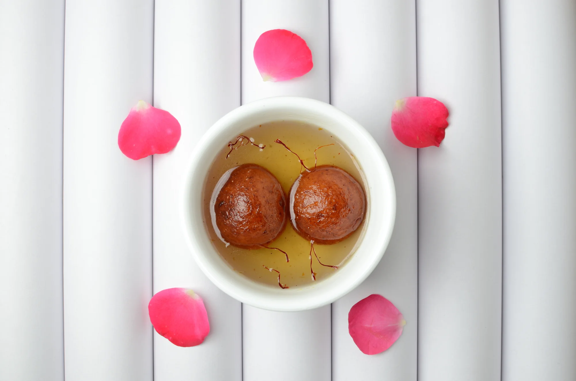Close-up of gulab jamun showing texture and syrup