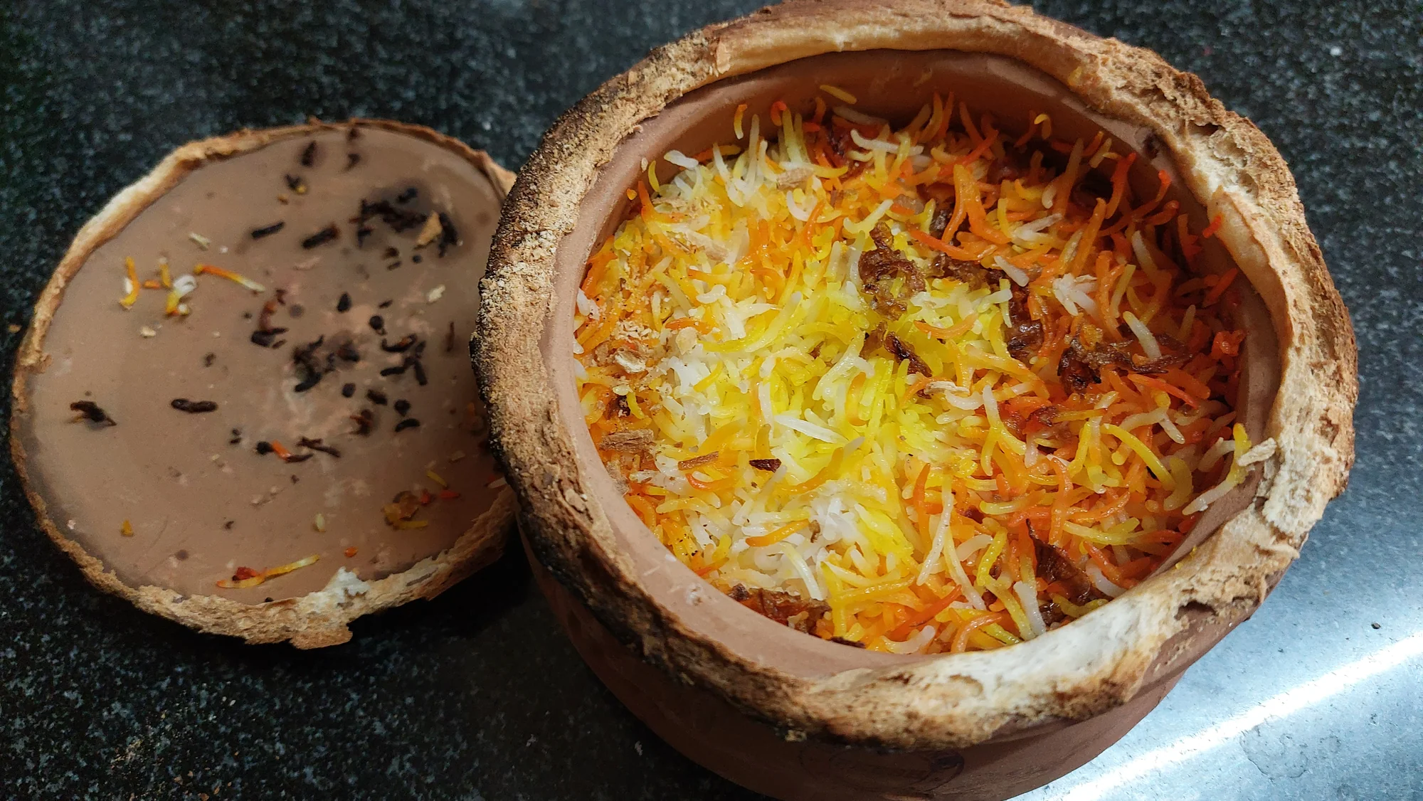 Lucknowi biryani cooked in an earthen pot (matka)