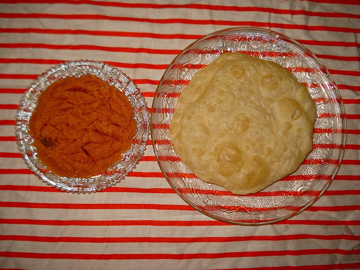Halwa poori platter with multiple accompaniments