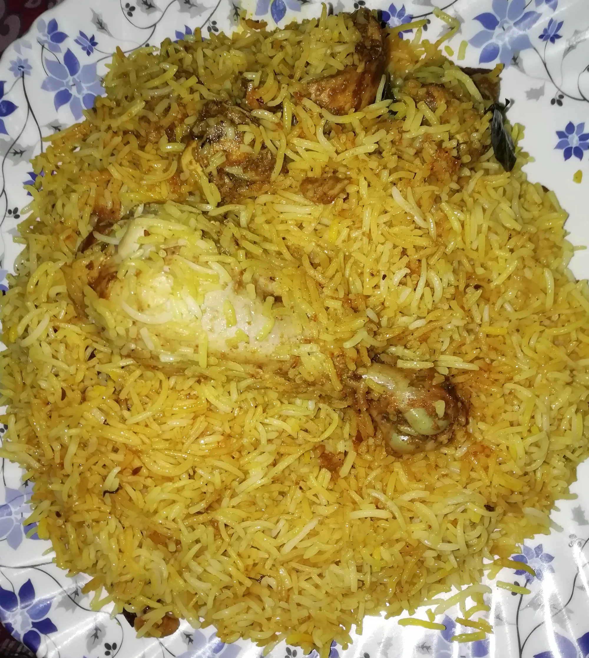 Hyderabadi chicken dum biryani with garnishes