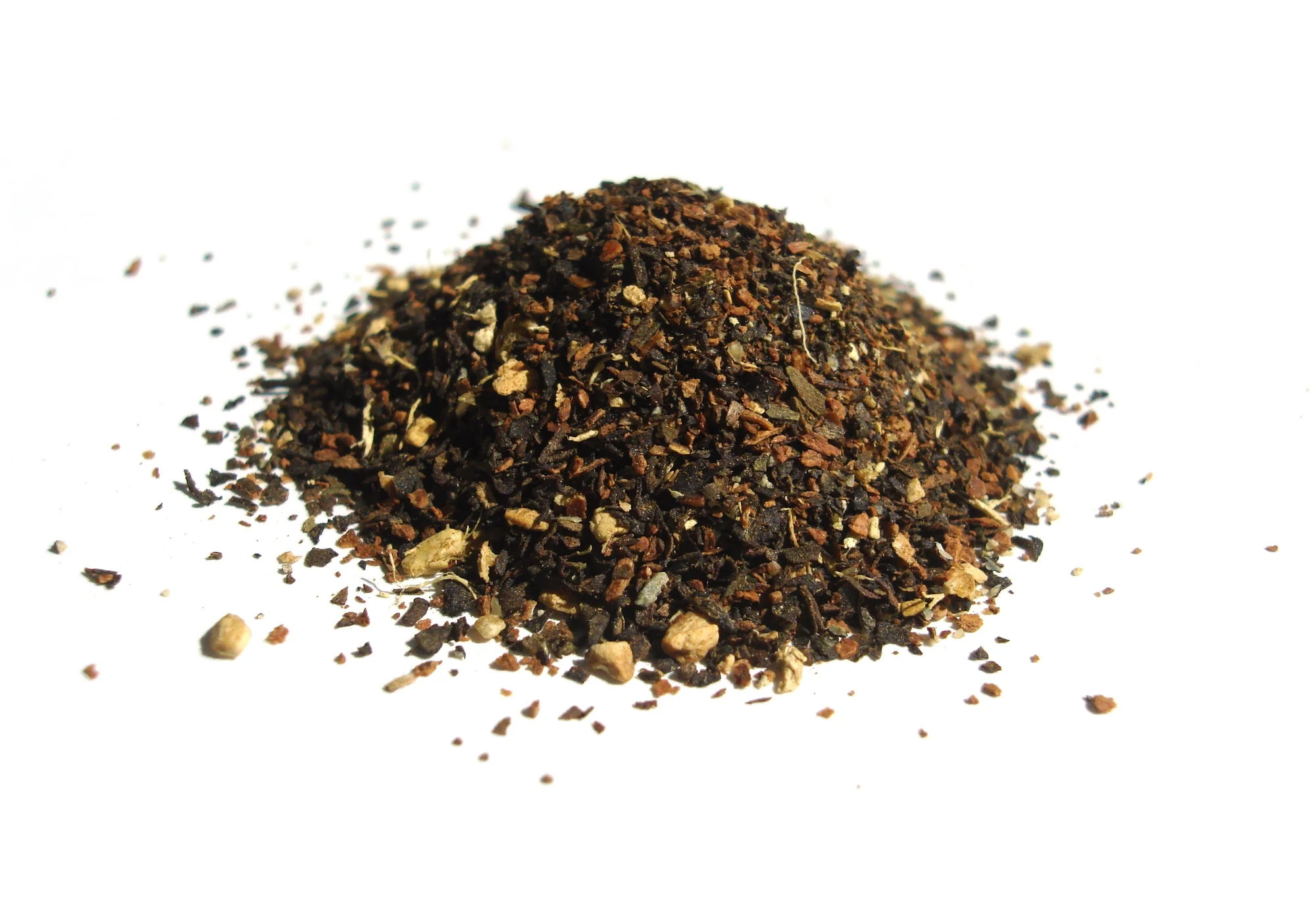 Dried spices and tea leaves typically used in masala chai preparation