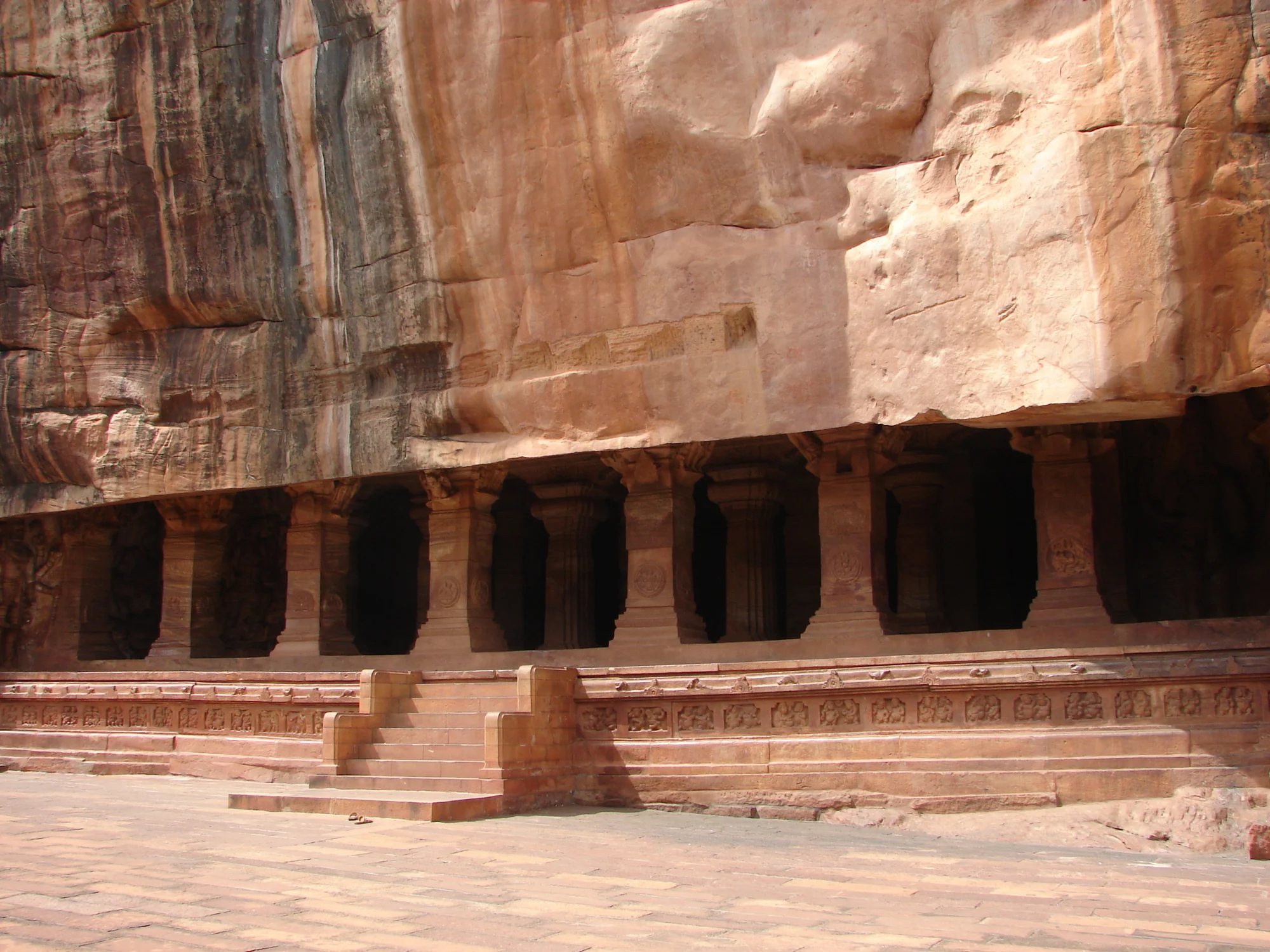Interior view of rock-cut cave temple at Badami with carved pillars