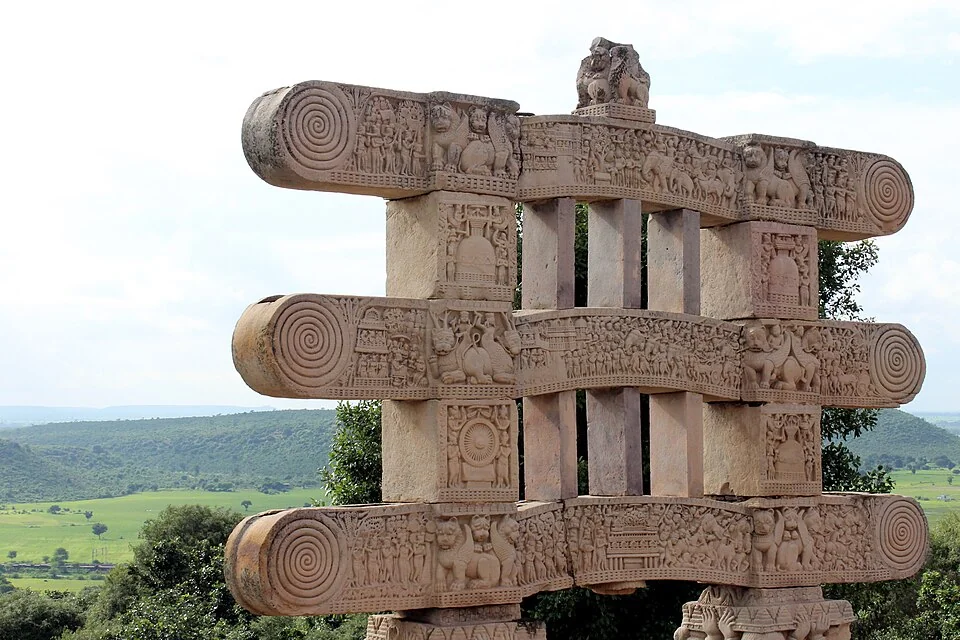 Ornate stone gateway showing Buddhist iconography