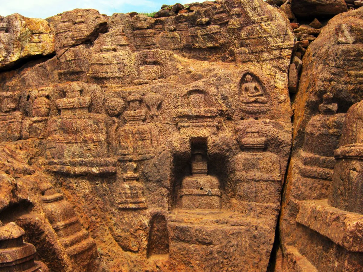 Rock-cut stupas carved into hillside
