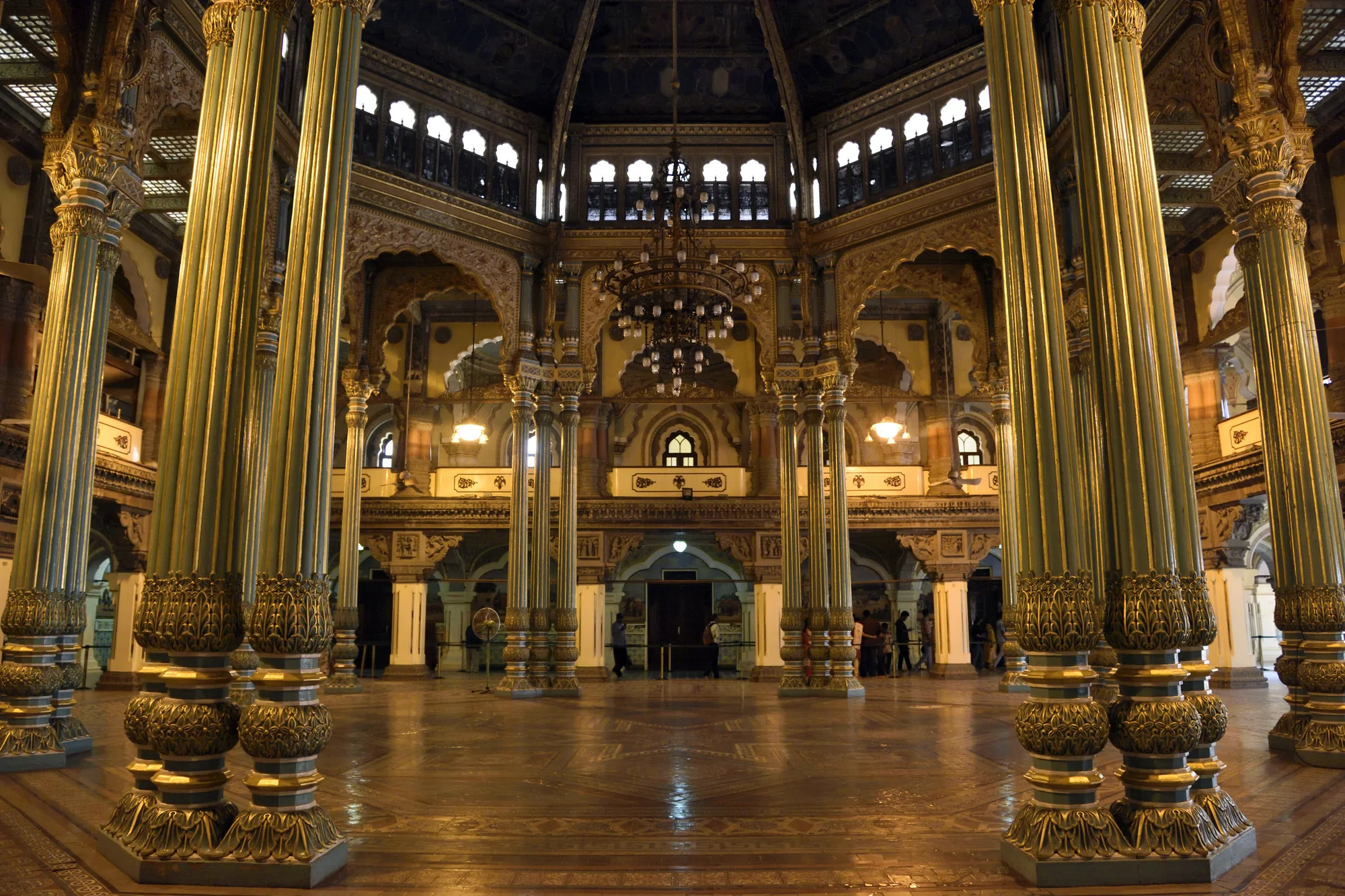 Interior of the ornate Durbar Hall with chandeliers and painted ceiling