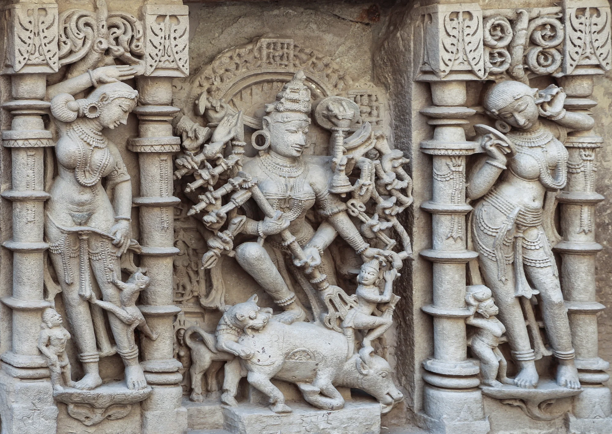 Multiple sculptures in niches along the stepwell walls