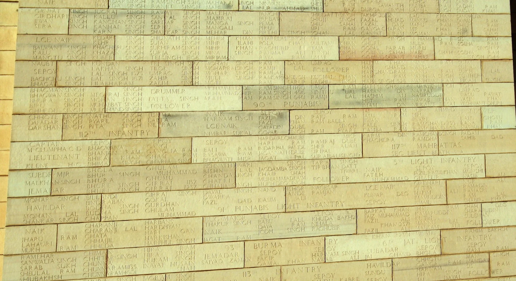 Close-up of inscribed names of fallen soldiers on India Gate walls