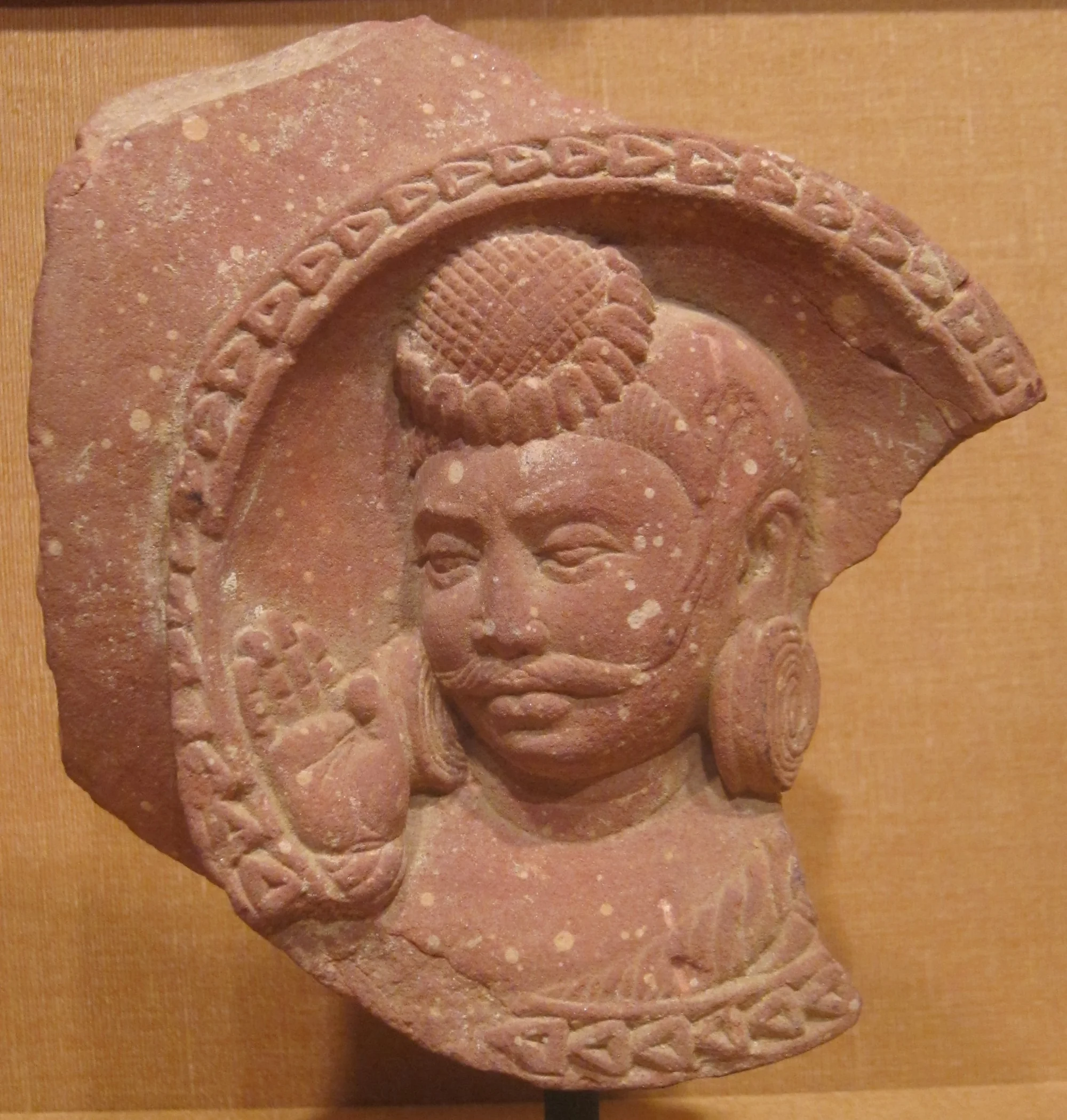 Pink sandstone sculpture roundel showing head of a nobleman from Mathura